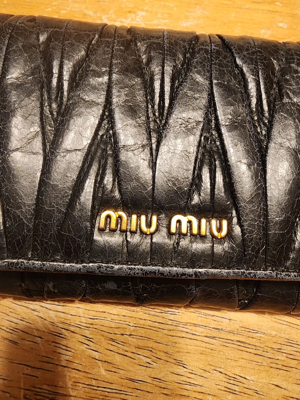 black quilted leather Miu Miu Matelassé long bifold wallet gold-tone Logo